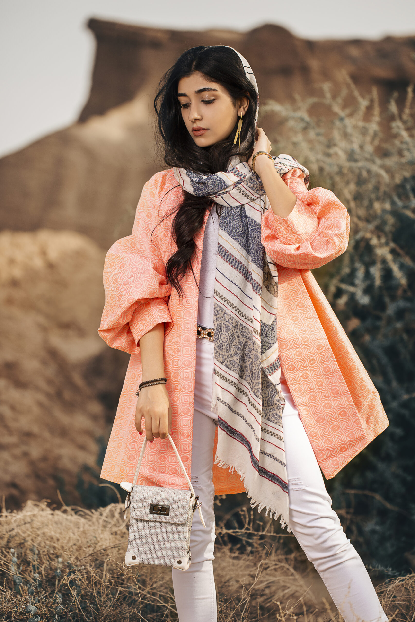 fashion model in coral jacket and black shawl